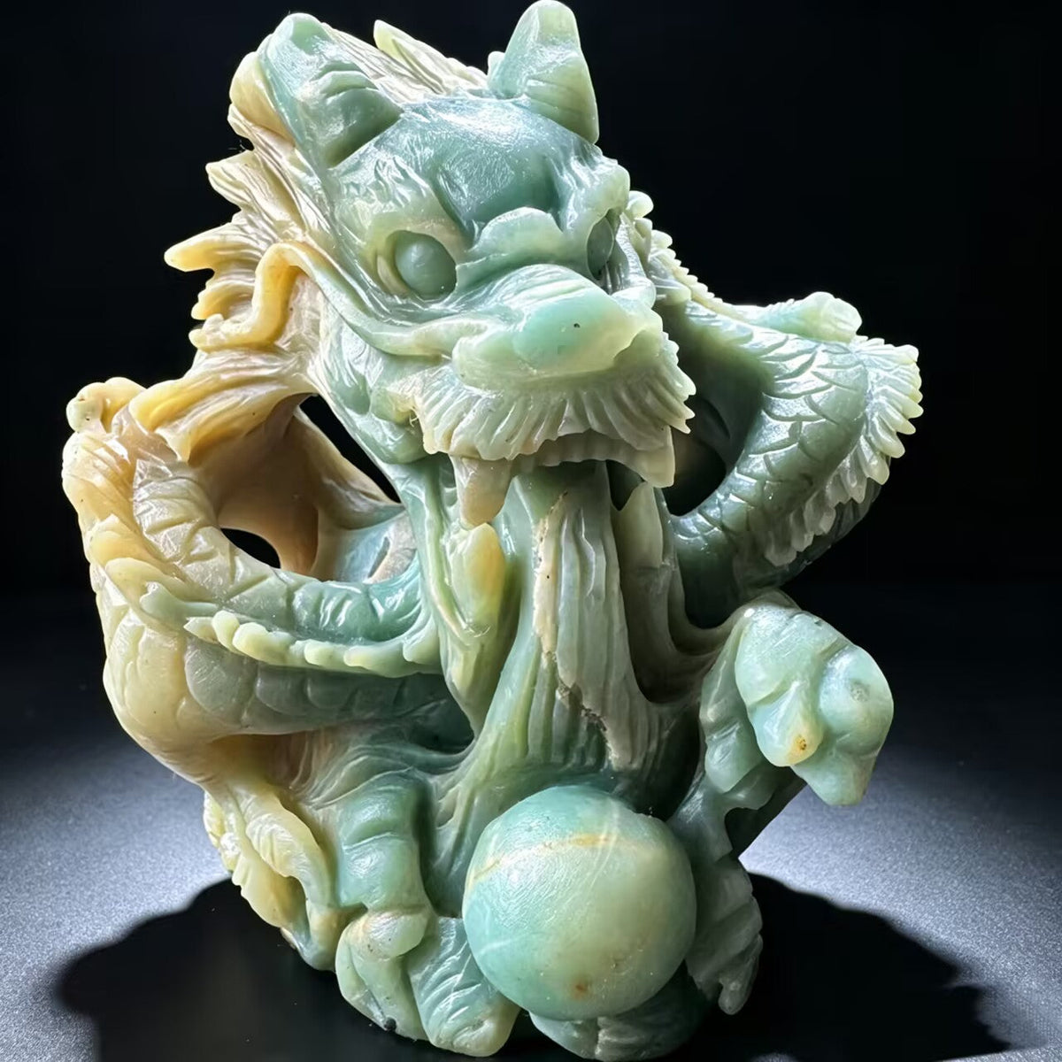 Close-up detail of the artisan's handiwork in carving the dragon onto the natural crystal.