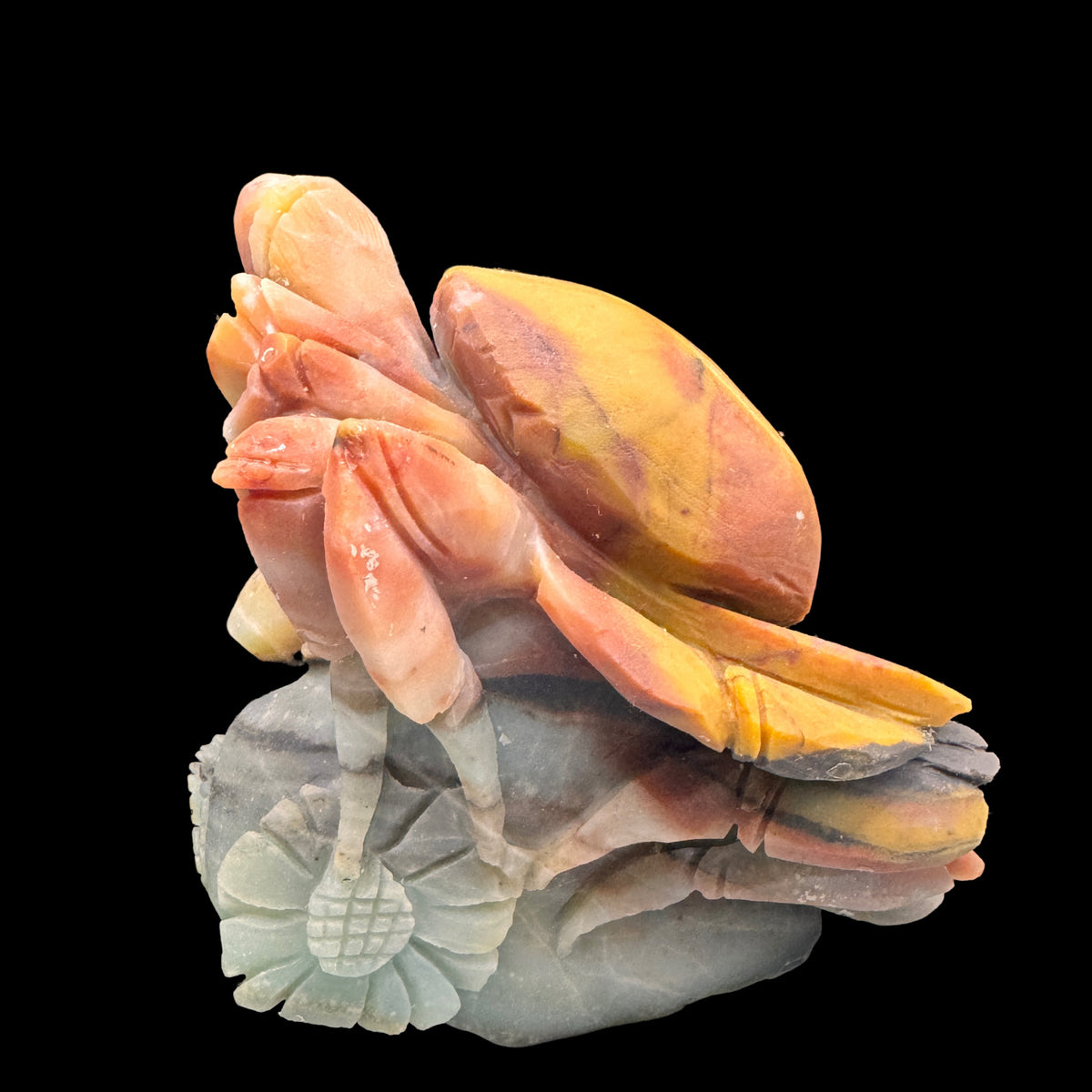 Side profile view showing the detailed carving of the blue Amazonite crab.