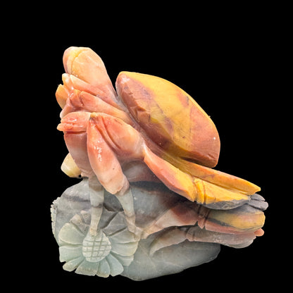 Side profile view showing the detailed carving of the blue Amazonite crab.