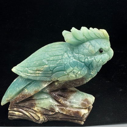 A side profile of the Amazonite parrot sculpture, highlighting the intricate details of its wings and tail feathers.