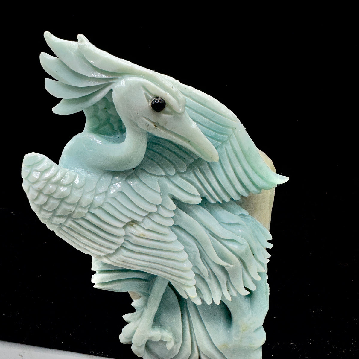 The bird sculpture positioned to symbolize clear and truthful communication