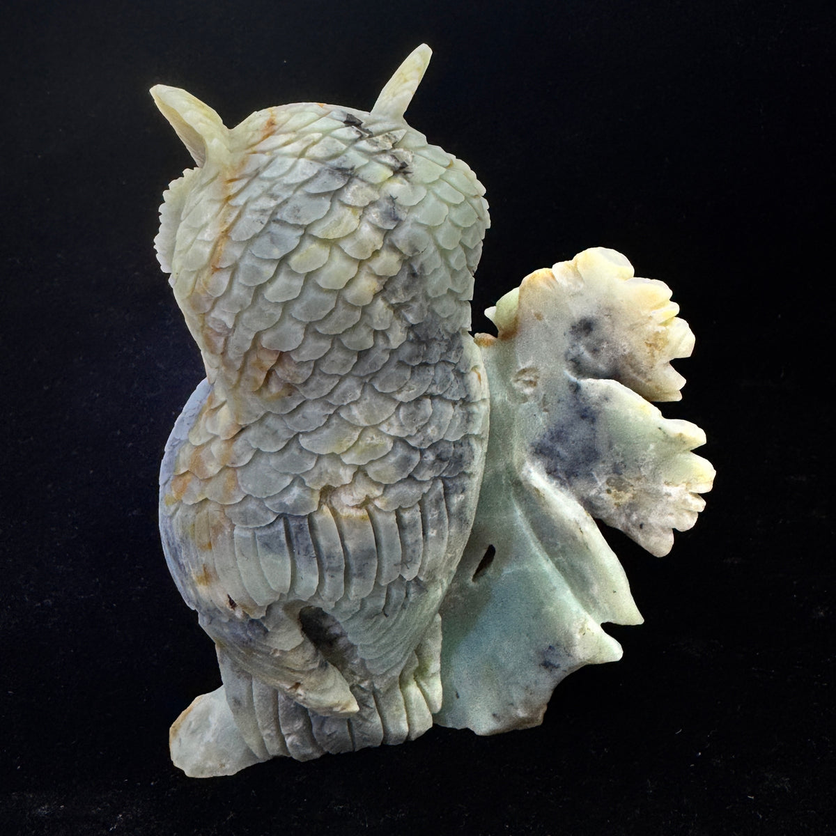  Rear angle of the carved owl, revealing artisan marks and its role in throat chakra healing.