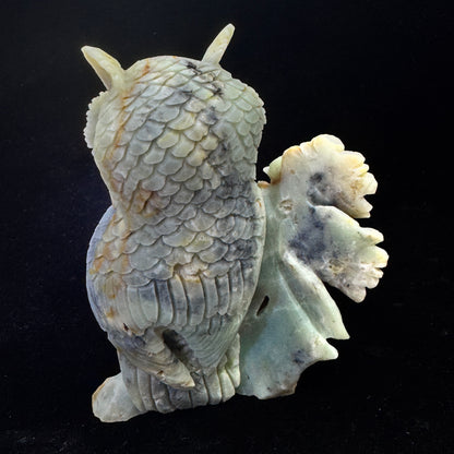  Rear angle of the carved owl, revealing artisan marks and its role in throat chakra healing.