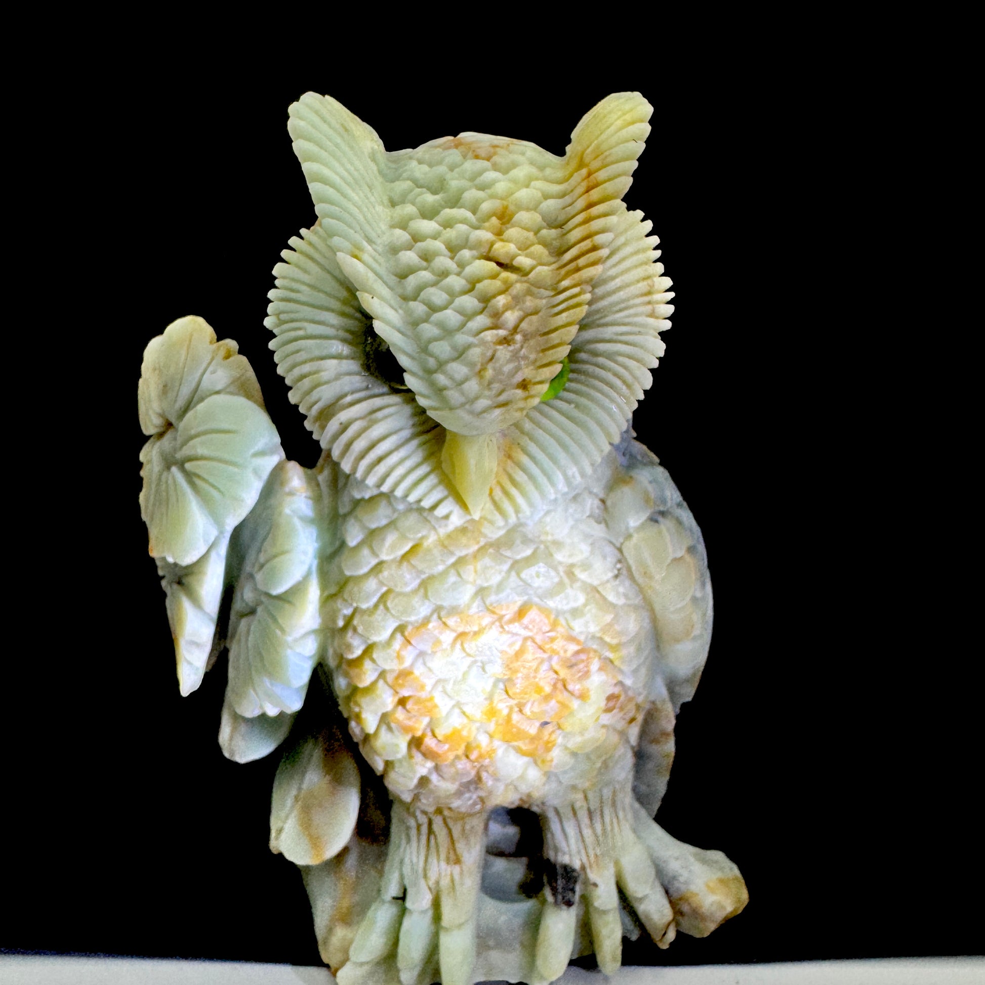 Side profile of the handmade Amazonite owl carving, highlighting its smooth curves and metaphysical properties.