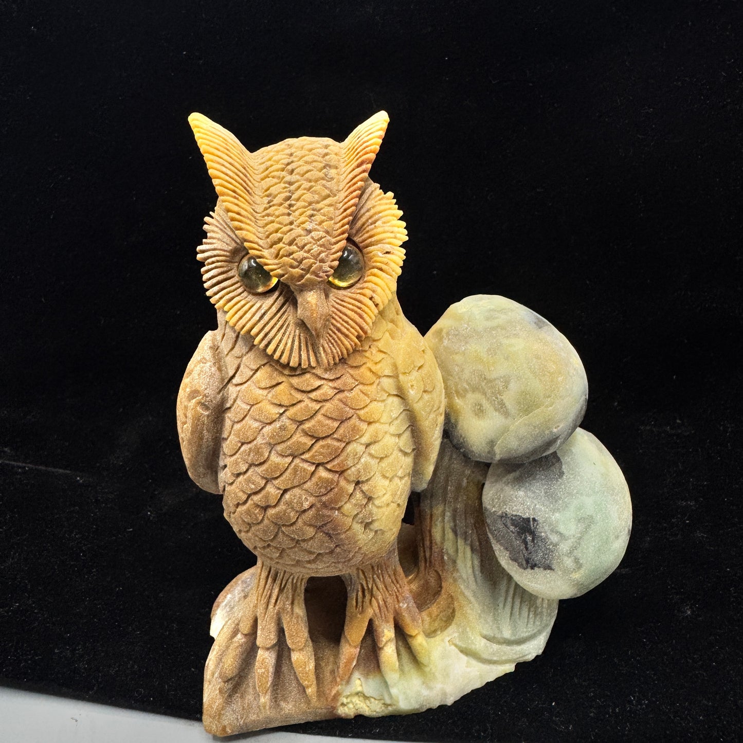 The owl sculpture symbolizing clear and truthful communication, aiding the throat chakra.