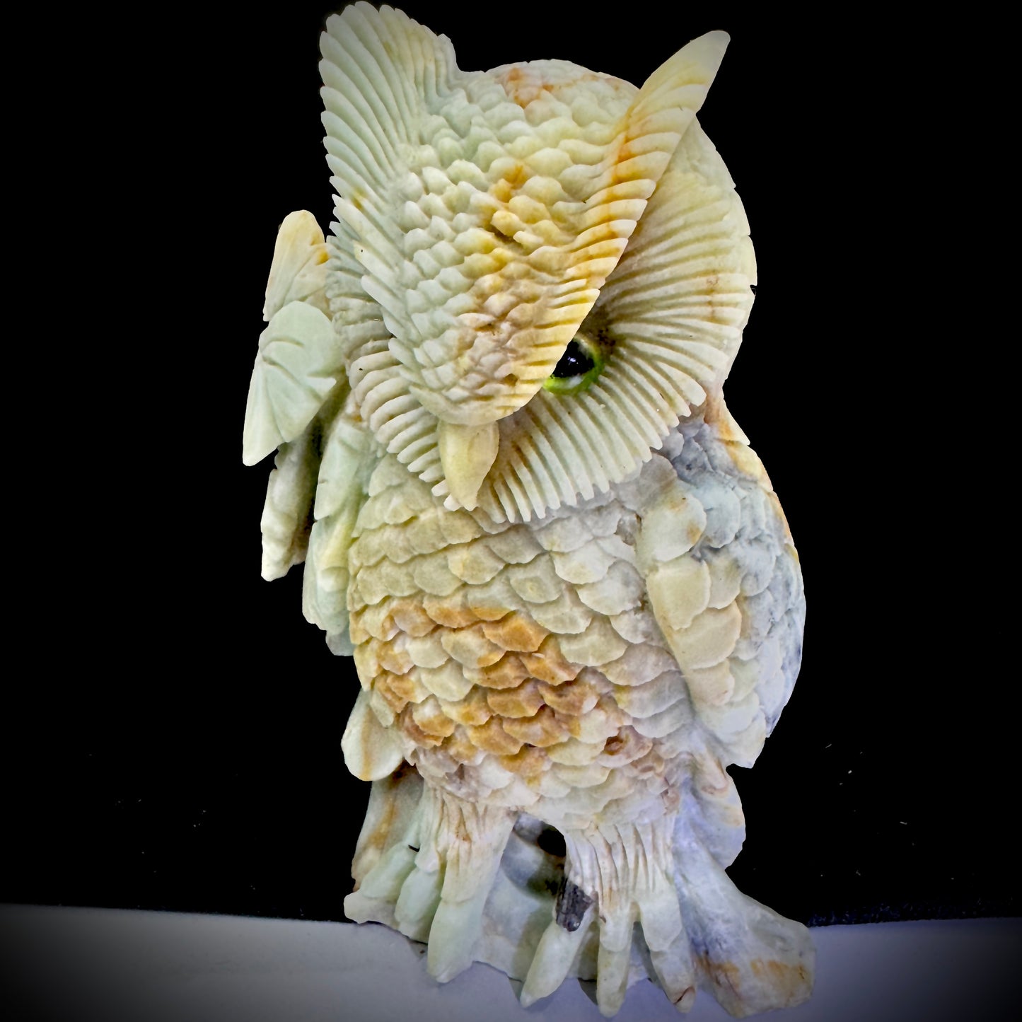  Decorative owl statue on a wooden shelf, symbolizing wisdom and enhancing home office vibes.

