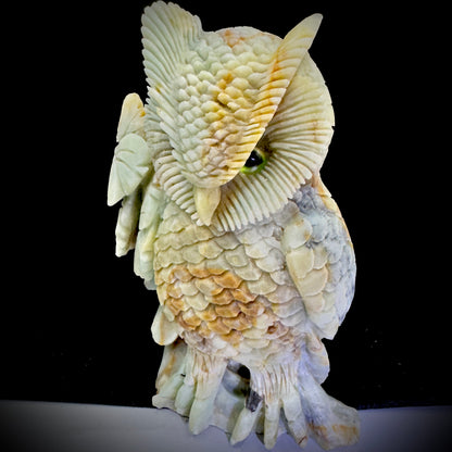  Decorative owl statue on a wooden shelf, symbolizing wisdom and enhancing home office vibes.

