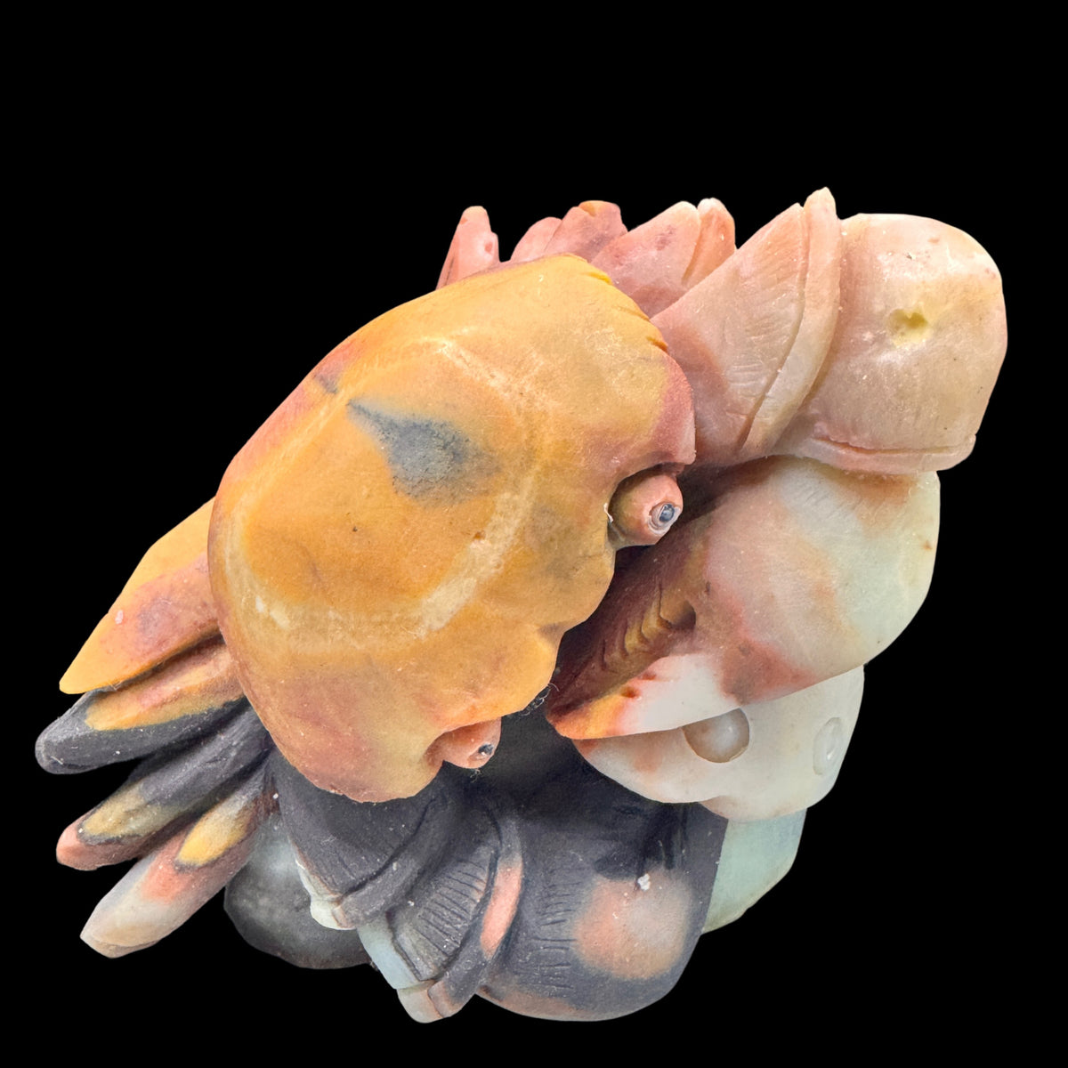 The crystal crab figurine resting on its raw Amazonite crystal base.