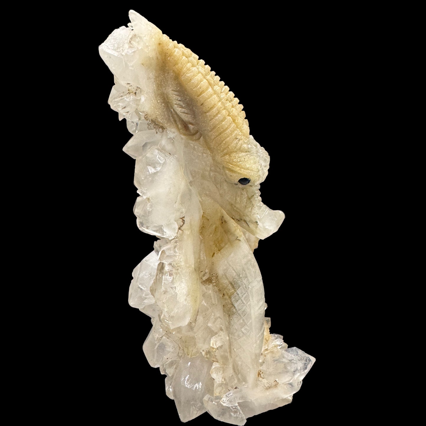Side angle showing intricate carvings on the white quartz dragon