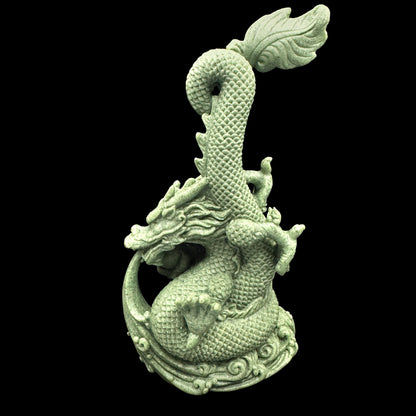 The mystical dragon carving displayed on a bookshelf, symbolizing wisdom and knowledge.