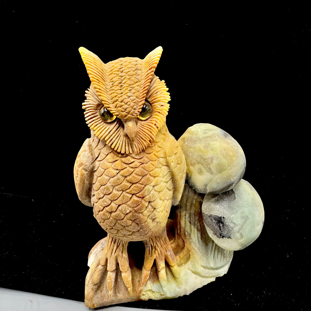  A wise-looking hand-carved owl figure made from natural blue-green Amazonite stone.