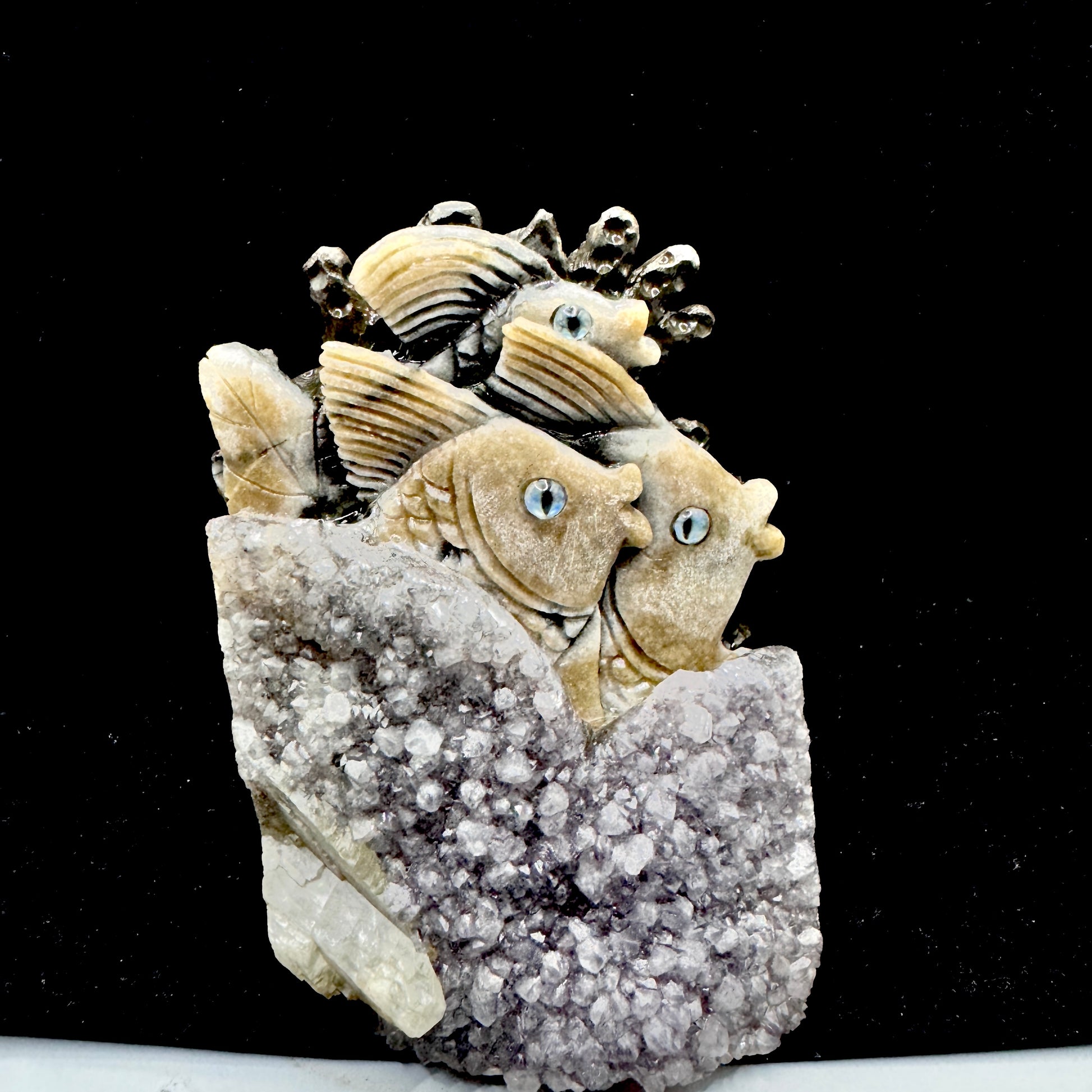 A mystical sea creature figure hand-carved from a natural deep purple amethyst cluster.