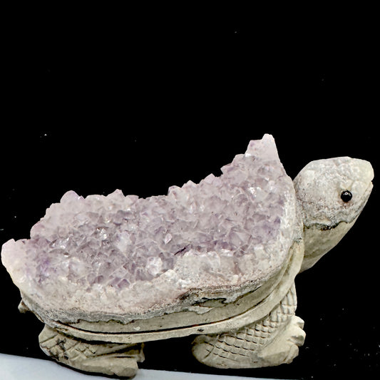 A unique tortoise figure expertly hand-carved from a natural amethyst cluster with multiple points.