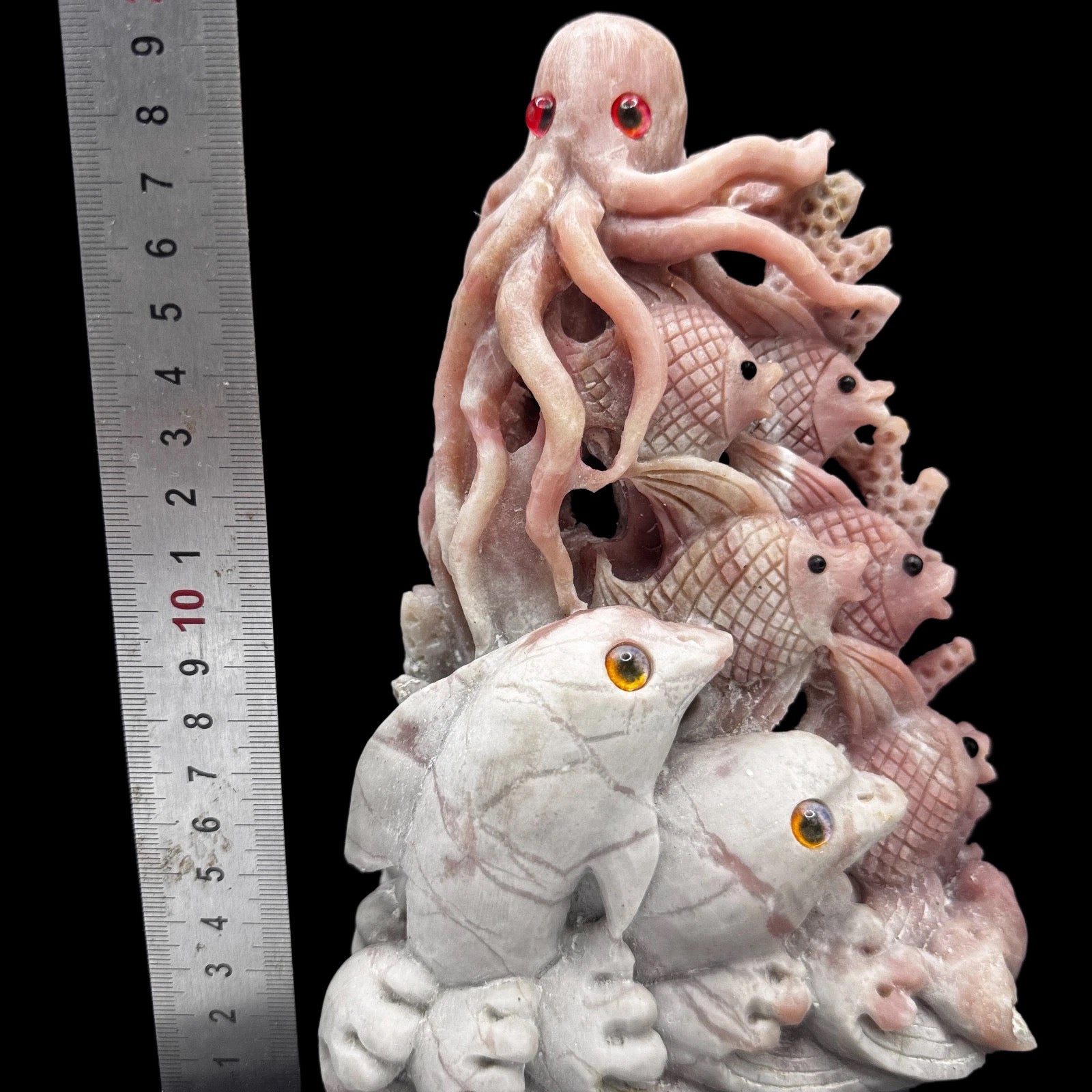  Front view of a delicate pink opal sea spirit sculpture, showcasing its smooth carving and ethereal color for emotional healing.