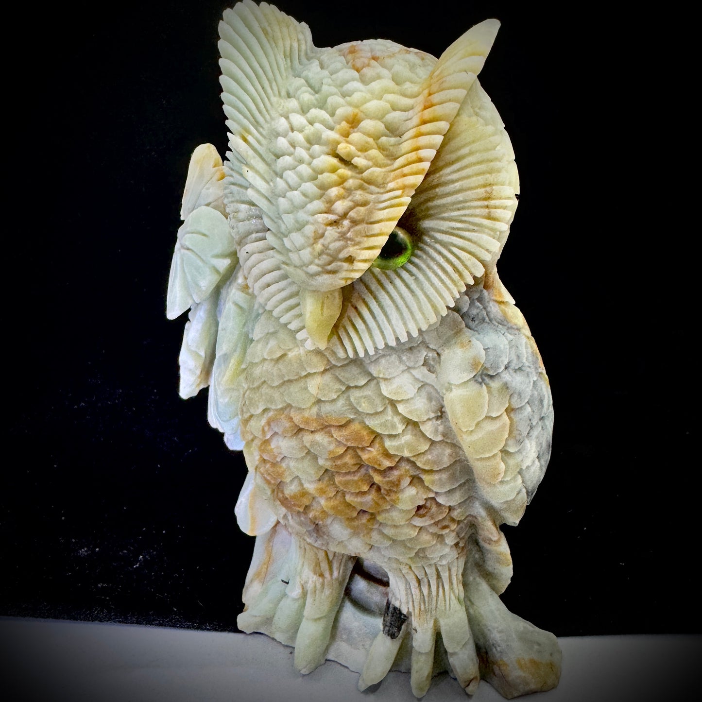 Person holding the handmade owl figurine, demonstrating its size and eco-friendly craftsmanship.
