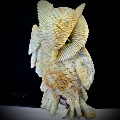 Person holding the handmade owl figurine, demonstrating its size and eco-friendly craftsmanship.