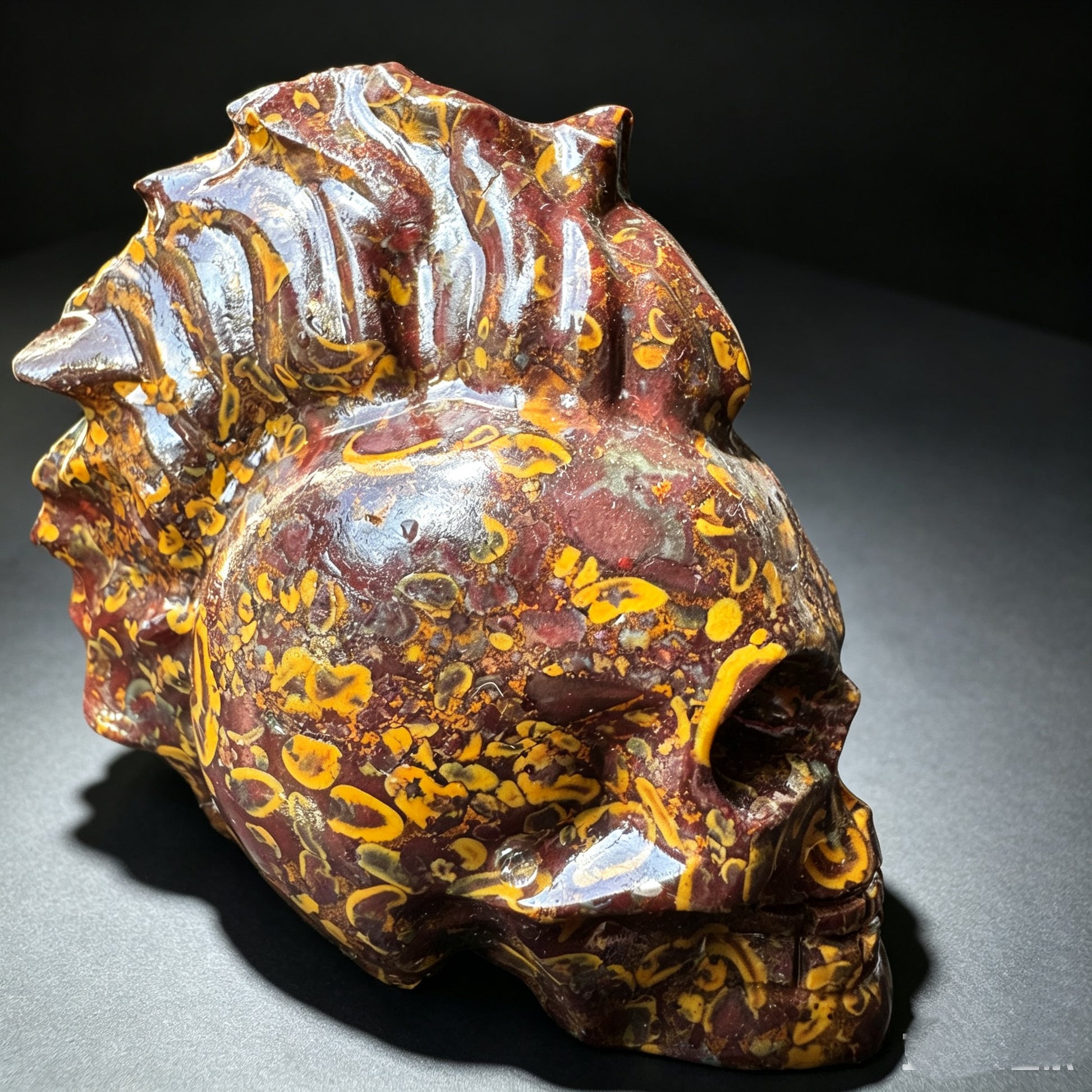 Natural stone carved skull sculpture, right front view.