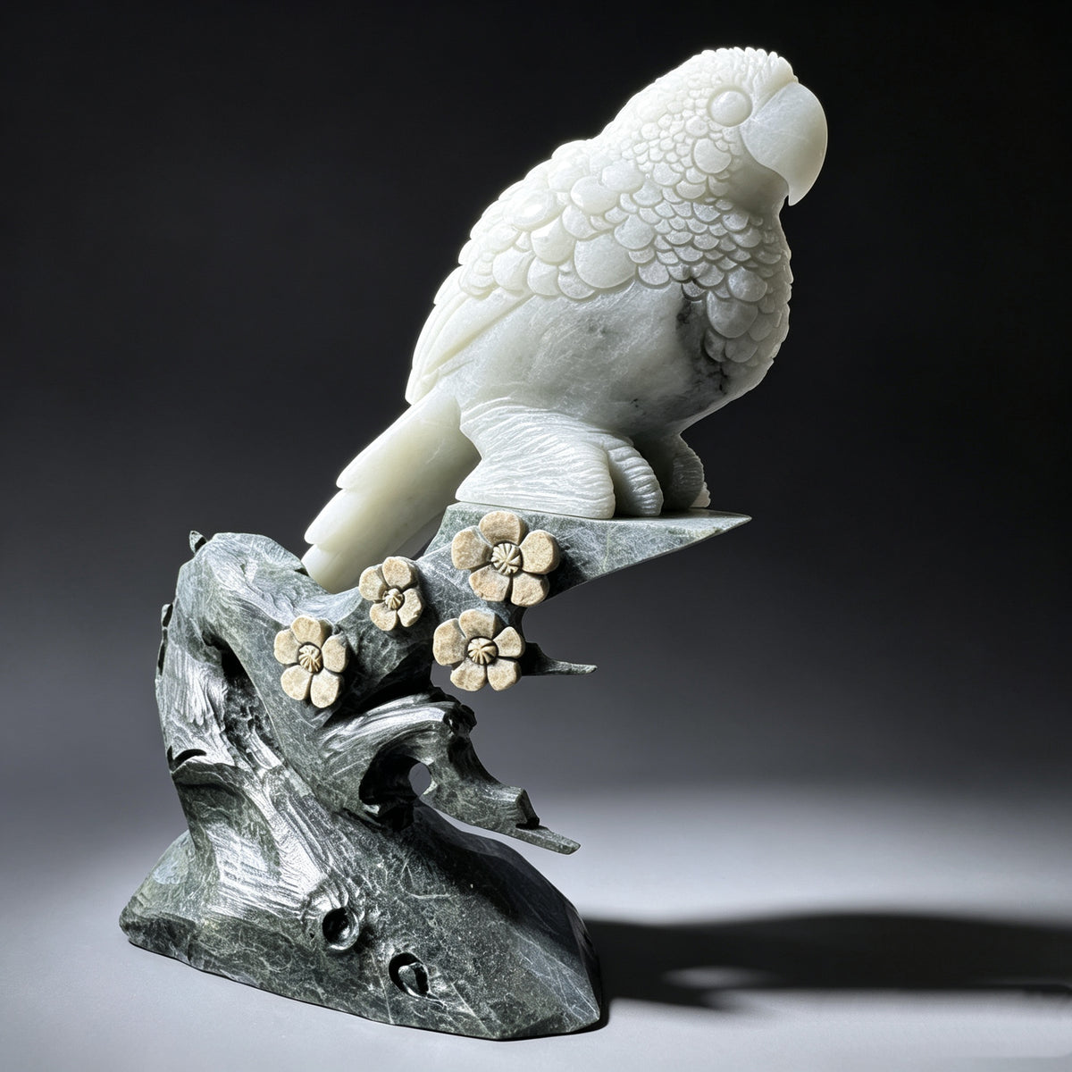 Natural stone hand carved parrot sculpture showing layered wing feathers and long tail from the opposite side.