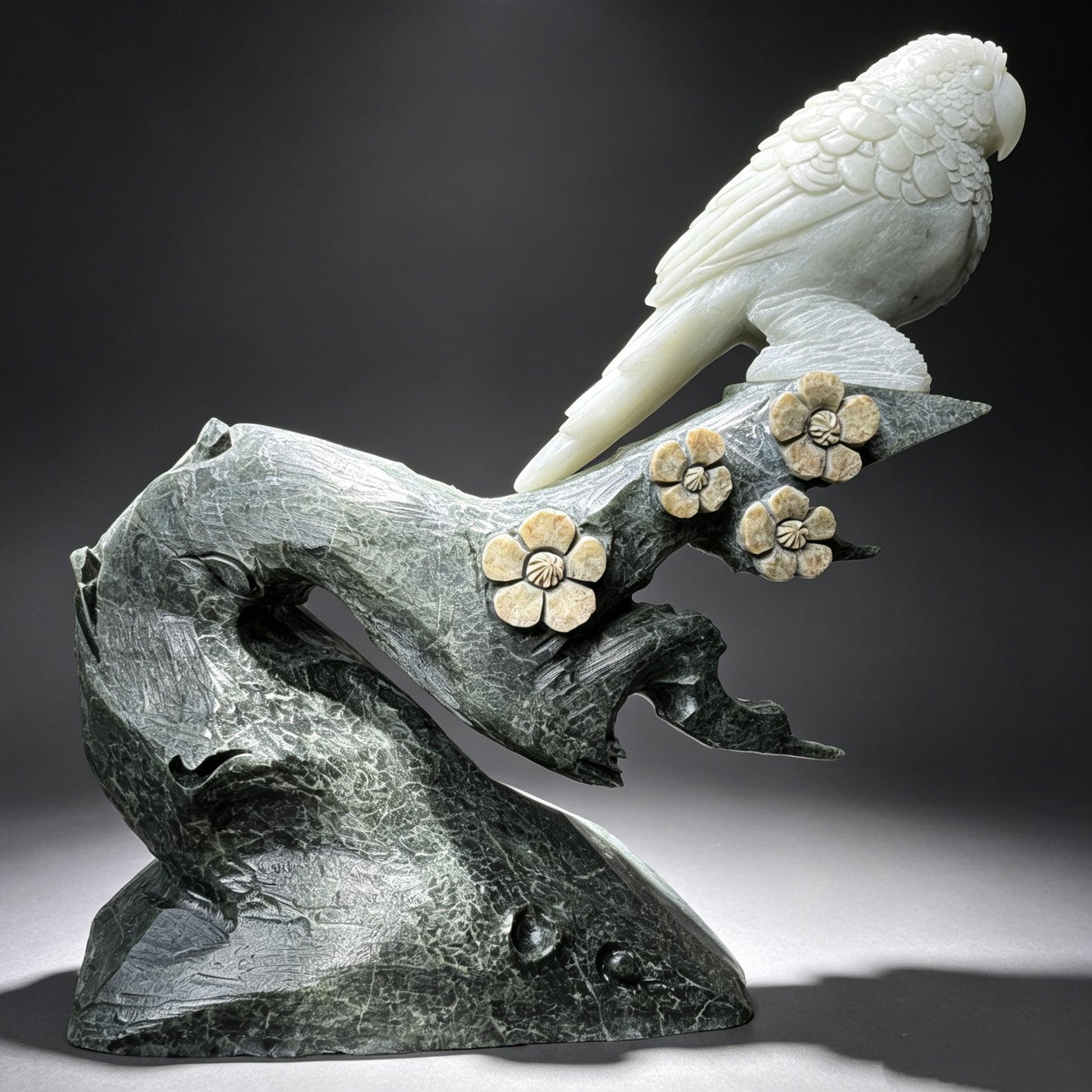 Natural stone hand carved parrot sculpture on floral stone branch, full side profile.