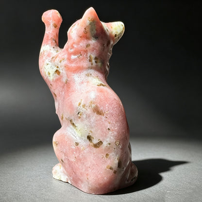 Natural stone carved cat figurine with one paw raised front view

背面图：