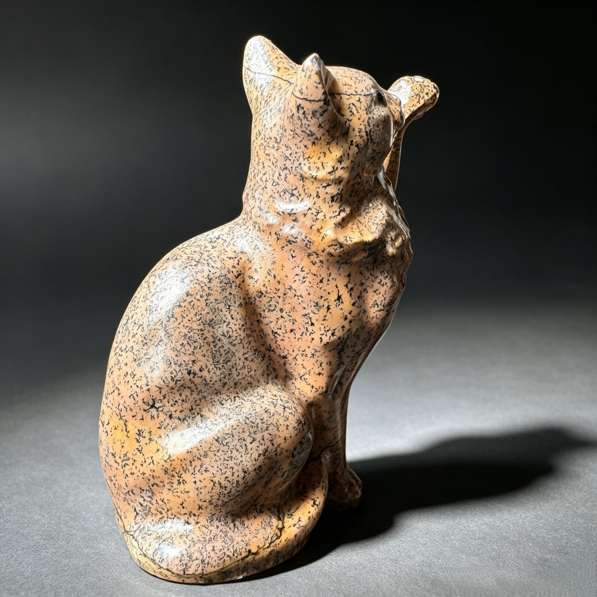 Natural stone waving cat figurine front view with raised paw