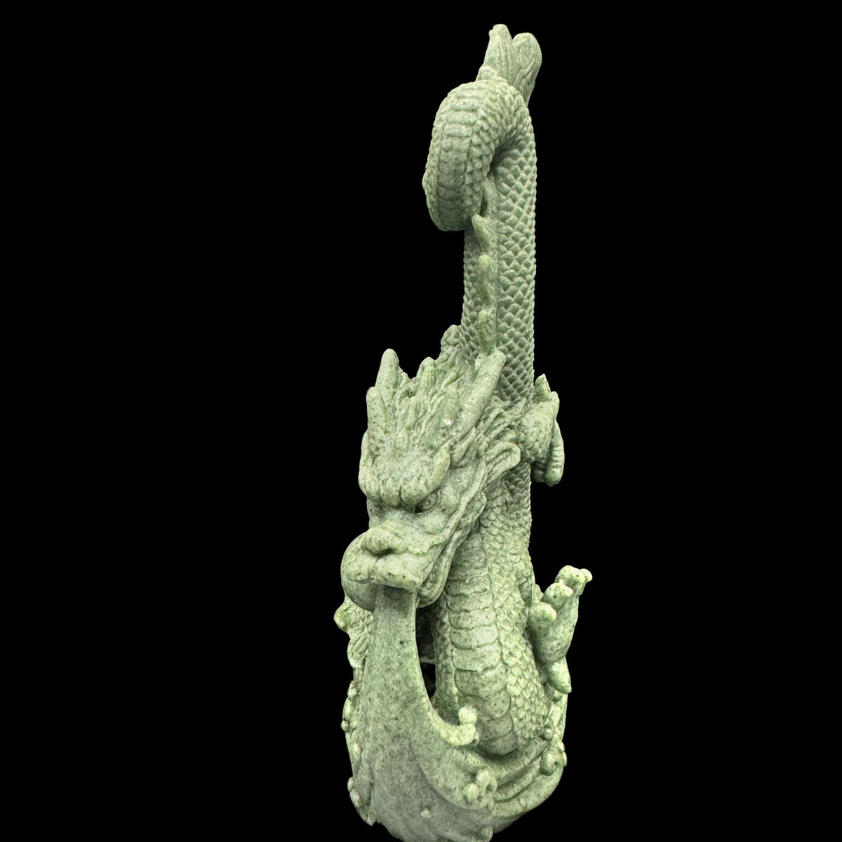 The statue positioned on a desk to absorb negative energy from electronic devices.