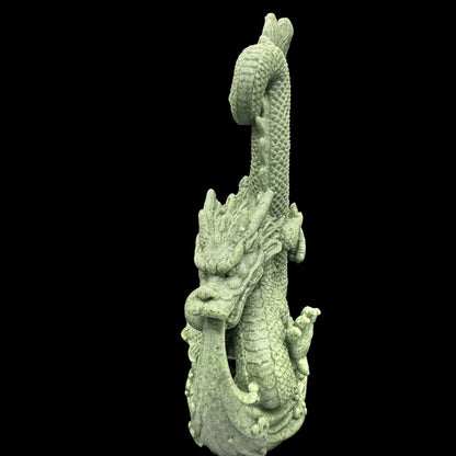 The statue positioned on a desk to absorb negative energy from electronic devices.