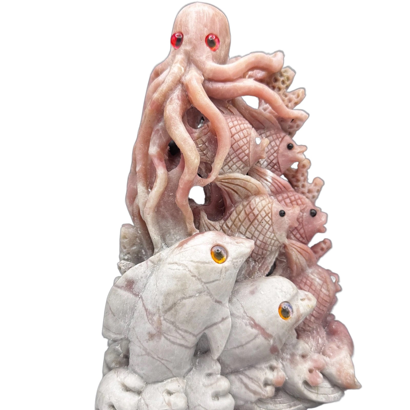 The pink opal sea creature placed on a meditation altar with candles, serving as a tool for intuition and inner peace.