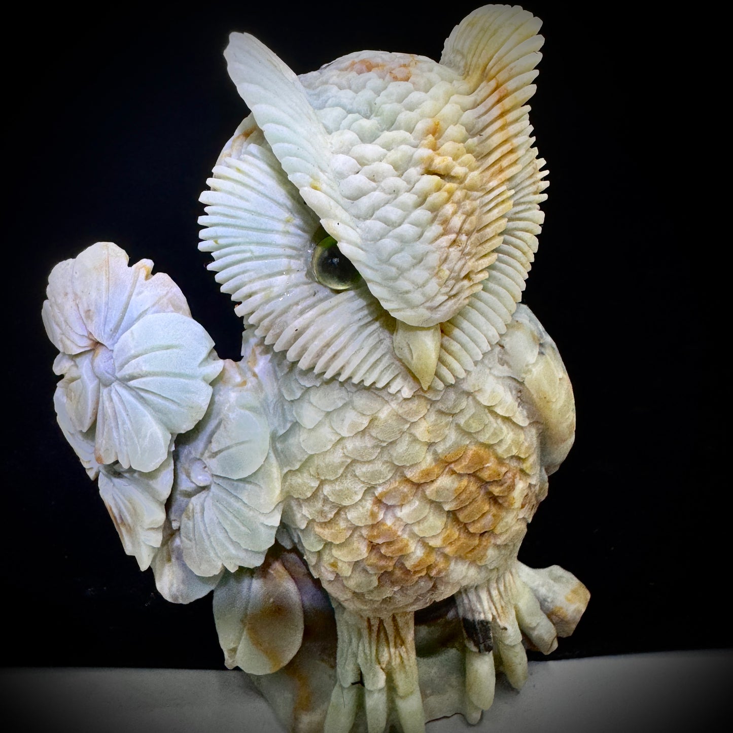 Amazonite owl placed beside candles and crystals, creating a serene space for chakra meditation.