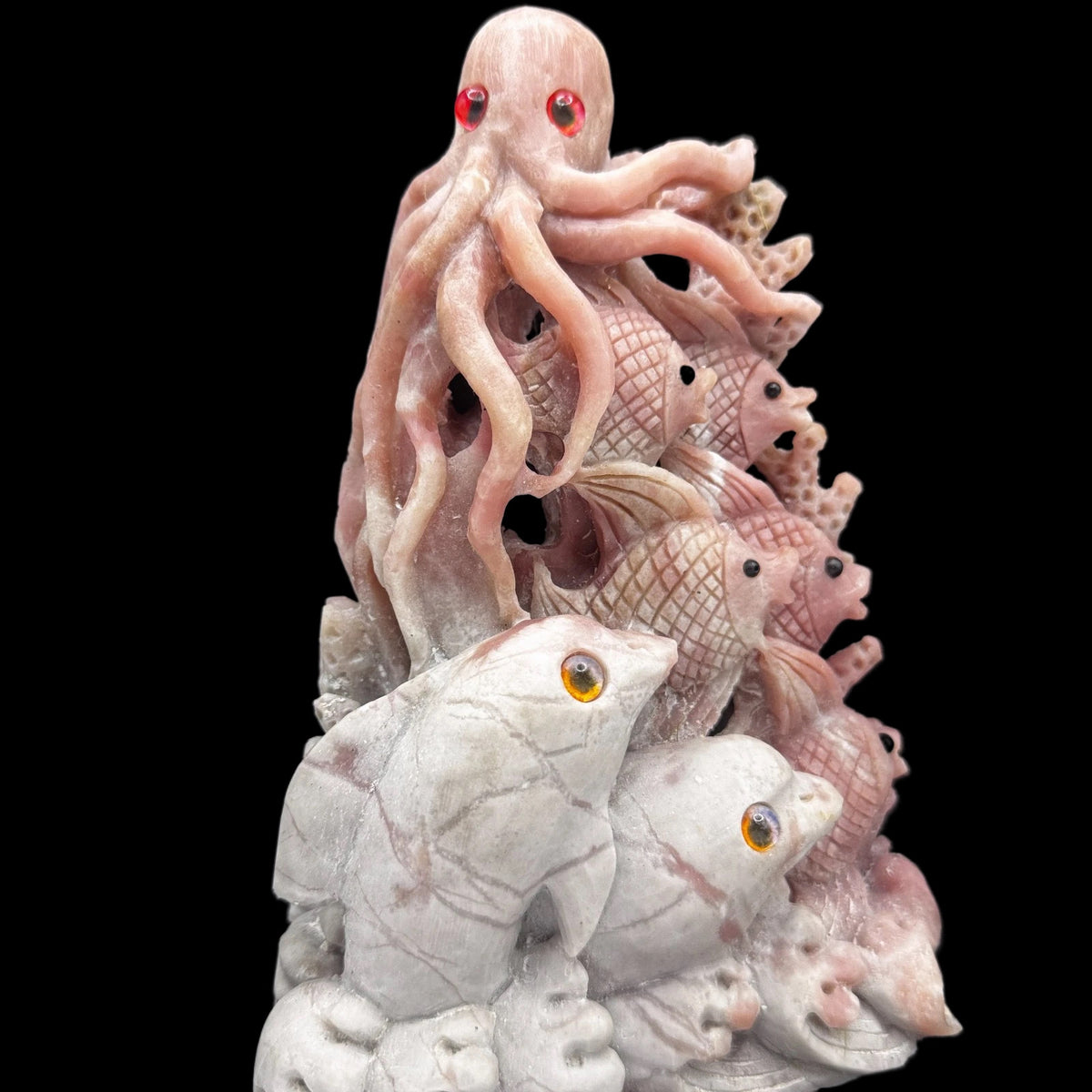 Close-up of the hand-carved pink opal ocean animal, highlighting the unique stone patterns and heart chakra energy.