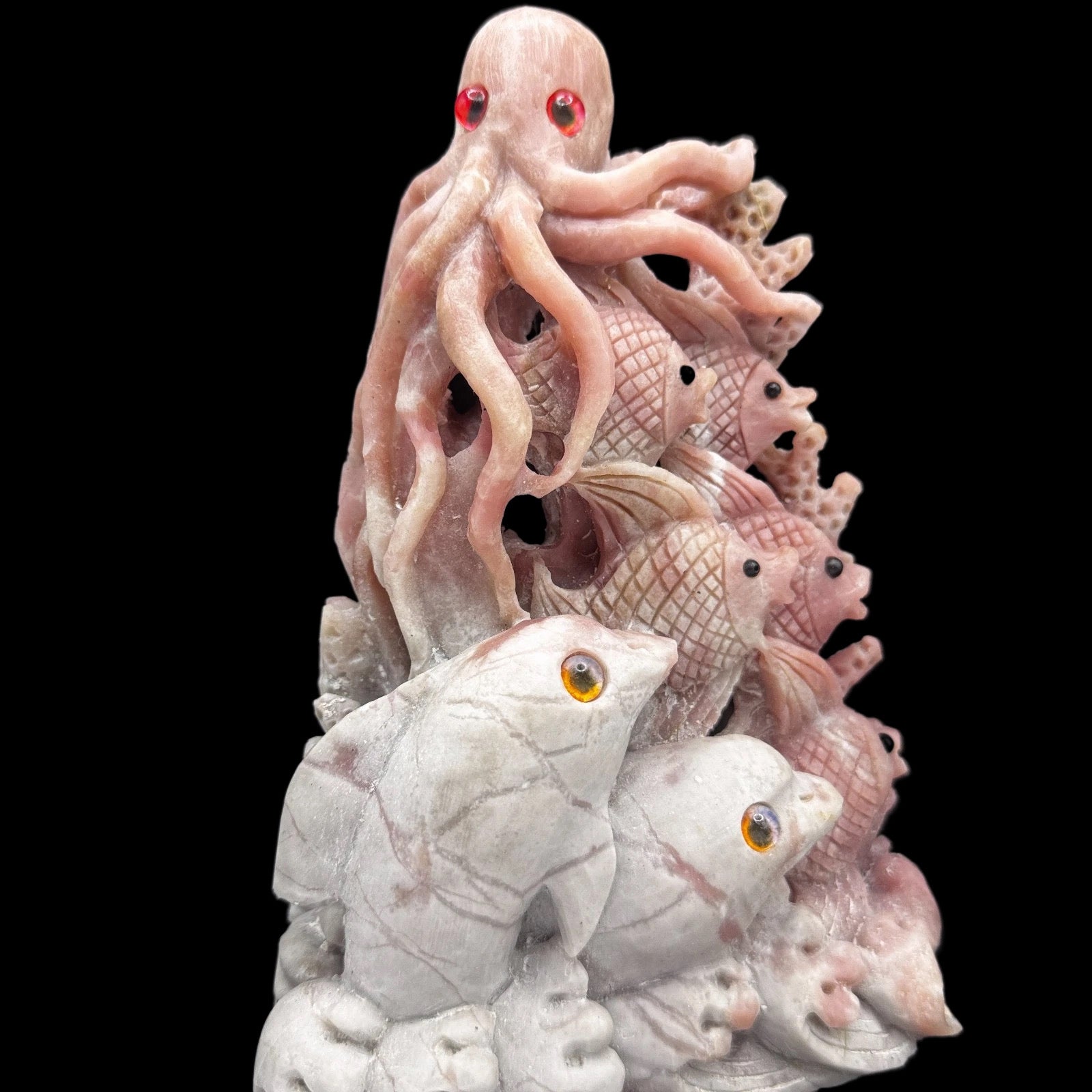 Close-up of the hand-carved pink opal ocean animal, highlighting the unique stone patterns and heart chakra energy.