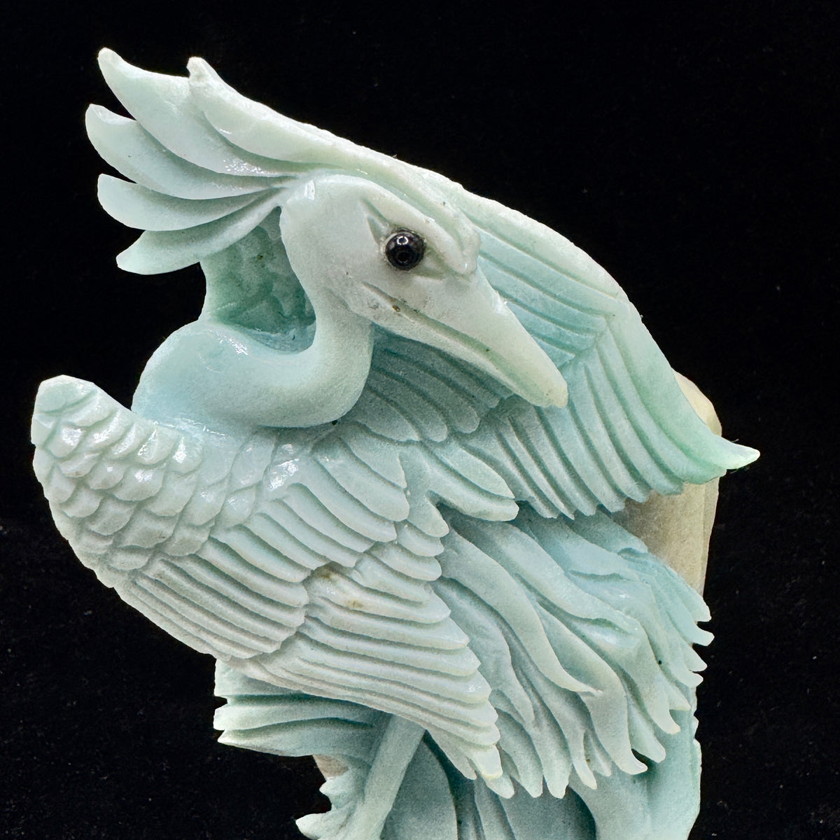 . The smooth, calming appearance of the Amazonite bird, promoting a peaceful vibe.