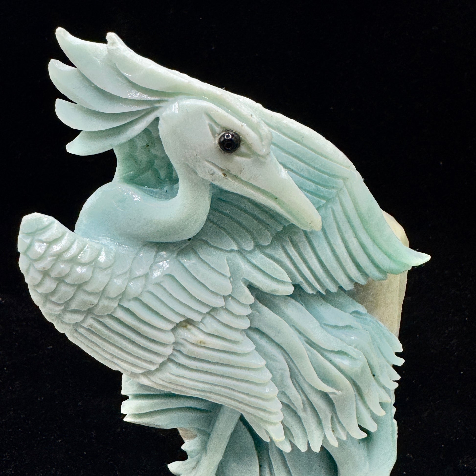 . The smooth, calming appearance of the Amazonite bird, promoting a peaceful vibe.