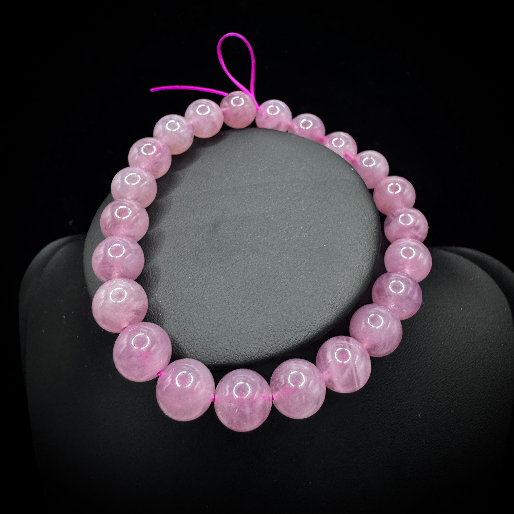 Close-up of purple agate beads, showcasing smooth polished surfaces and fine textures.