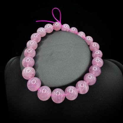 Close-up of purple agate beads, showcasing smooth polished surfaces and fine textures.