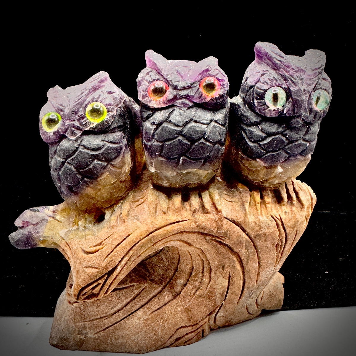 Close up detail of hand carved feather texture on fluorite owl sculpture