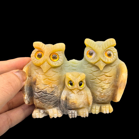 Front view of the handmade owl family carving on a natural Amazonite cluster.