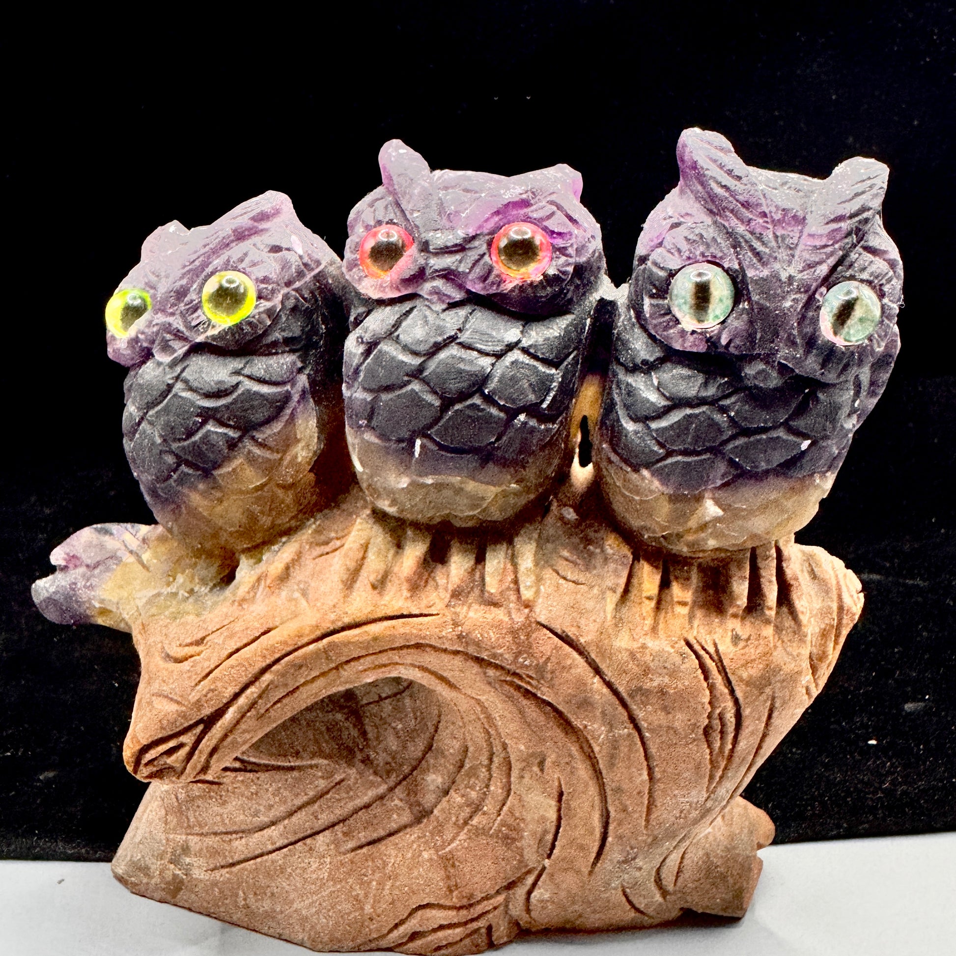  Front view of three fluorite owls symbolizing wisdom and family connection
