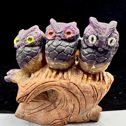  Front view of three fluorite owls symbolizing wisdom and family connection