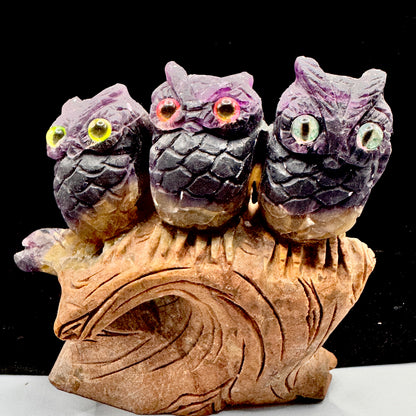Rainbow fluorite owls showing natural purple and green color zoning in sunlight