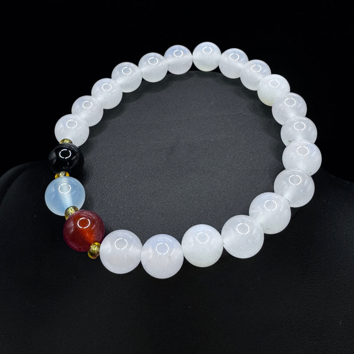 The model wears a jasper bracelet on her wrist, showcasing the elegant effect of her everyday outfit.