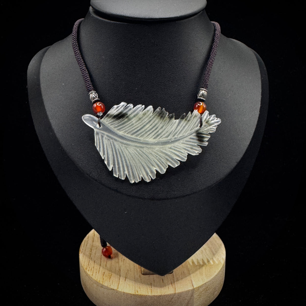 Hand carved natural Xiuyan rock feather pendant on silver chain


